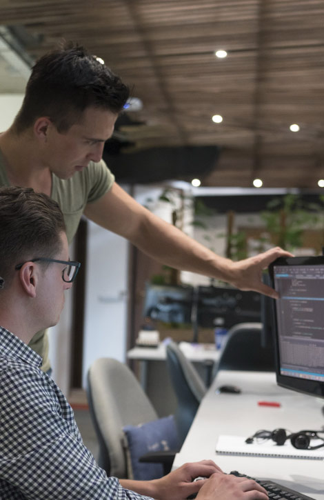 two men looking at computer